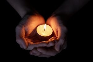 Female Teen Hands Holding Burning Candle